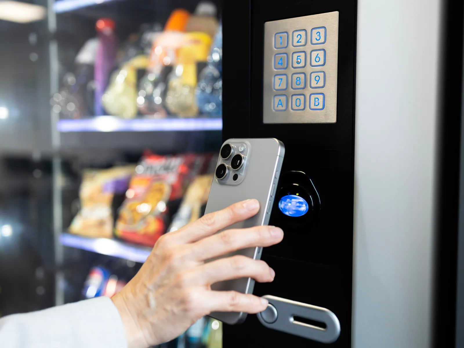 Customer using a mobile wallet at a vending machine card reader