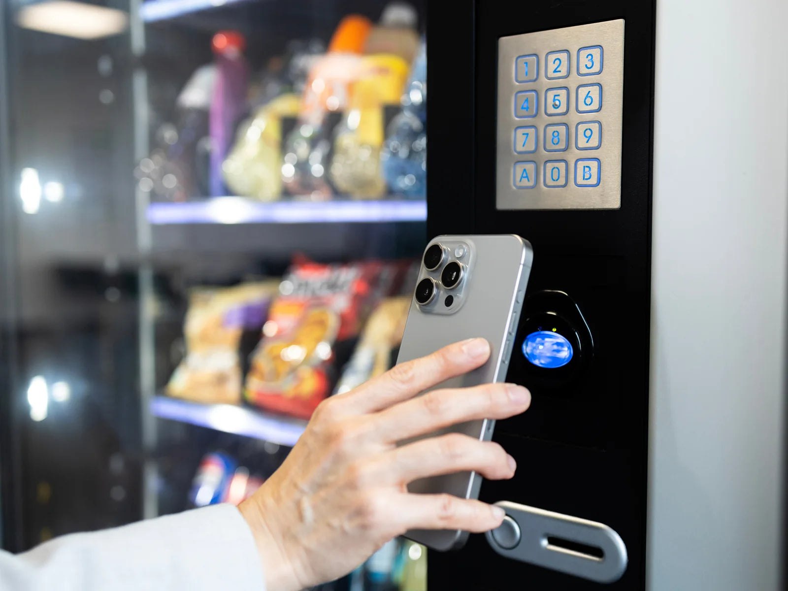 Customer using a mobile wallet at a vending machine payment reader